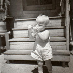 Cathy enjoying her first brew, 1944
