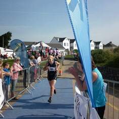 Celia powering through the finish at her first open water tri (Gower)