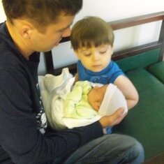 Chad letting big brother Trevor hold his baby brother Parker at the hospital