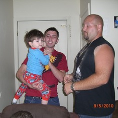 Chad holding Trevor with Dusty visiting Parker coming home day