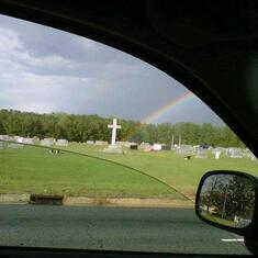 11OCT13-Rainbow rises from our house in woods behind the cross at the time Chris died