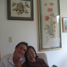 July 2010: Chris kidding around with his grandmother, Li Lienfung, with three different needlepoint she had made in view.