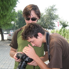 Chris checks out an image on Danfung's Canon 5D Mark II camera outside the water polo building at the Beijing Olympics.