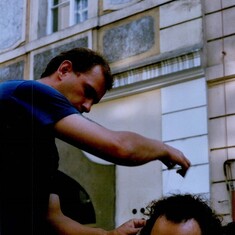Chris in Prague getting his hair braided