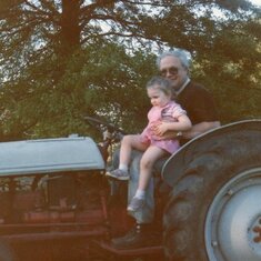 Ashley & Grandpa on the tractor in Chandler
