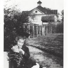 Photo of his best friend and cousin Margaret Barber Smith n front of the Leffland home in Victoria, Texasin the early 1900's.