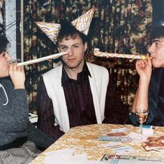 Claude playing monopoly with friends in Windsor, ca. 1984