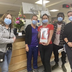 Claude's sister and Scott give flowers to the staff at the Saint Jerome Hospital on Oct. 25