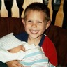 Clayton holding newborn Nate. The smile.