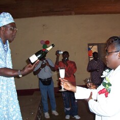 Tita Gwandiku pops a champagne in celebration of our civil wedding at the Bali council hall, 2005