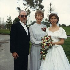 Lisa with parents at her wedding 