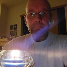 Dennis K.. lighting a candle