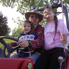 Papa's red tractor rides
