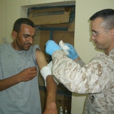 Daniel Bandaging Iraqi soldier in Iraq.