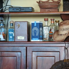 The original urn among the tequila bottles