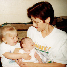 Darlene helping her granddaughter, Amanda (Carrie's daughter), hold her granddaughter, Jayme (James' daughter), in 1998.