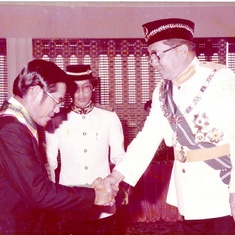 Charles being conferred his PGDK