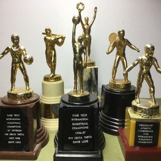 Some of David's Trophies: David played many different sports in school. In later life he continued to play tennis, badminton, racquetball, and golf, and he liked to ski.