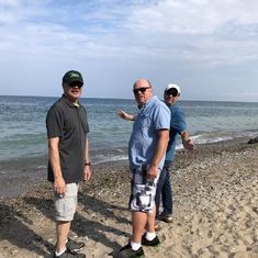 Dennis, Dave and Tom skipping stones.