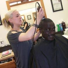 Mola Manyanye having his haircut