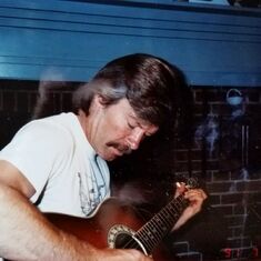 Here's a photo of David doing one of his favorite things, playing guitar....