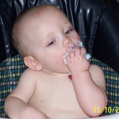 Eating cake on his first birthday
