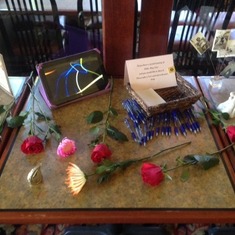 Table with a small un of moms ashes (tear drop), note cards for people to share stories. Celebration of life in Portland Oregon 4/18/15
