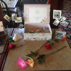 table with photos of mom and hearts filled with flower seeds to plant in memory of mom and a mold of moms and my hand. Celebration of life in Portland Oregon 4/18/15
