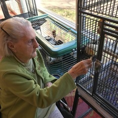 Denise sneaking the birds crackers at Delmar Gardens