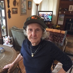Denise wearing Gene's fishing hat he left at her condo