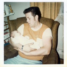 My father holding me as a baby.