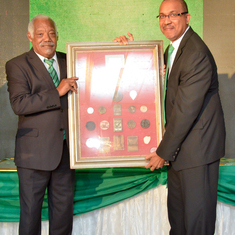 DJ handing his medals to COBA President David Miller.  Medals are showcased in Calabar Museum