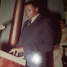 Desmond reads the lesson at a church service.  Photo kindly provided by Edward Fashole-Luke II