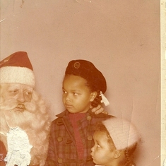 Diane and sister Cynthia with Santa - I think she's wondering is he really Santa? Diane questioned everything!