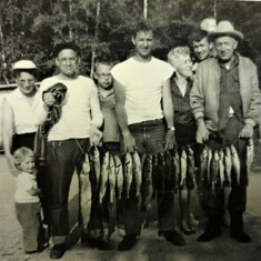 Don (center) with family and fishing haul