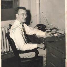Perhaps at his desk in his first job as a management intern @1952