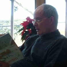 Reading to his family on Christmas morning