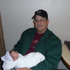 Dad holding Alex after she was born