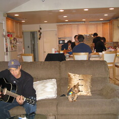 Dad playing the guitar with Toby doggie, Thanksgiving 2008