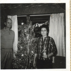 Dad and mom celebrating Christmas long ago..
