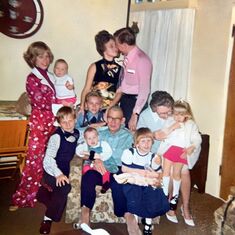 Nancy and Don Hill kiss among the family