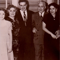 Mom with her two siblings and parents. Circa late 40's, I'm guessing.