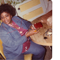 Mama in her 70'a kitchen getting ready to smoke a cigarette.