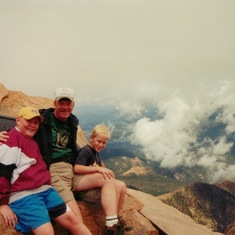 Doug and his boys, high on a mountain.