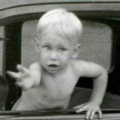 Doug waving from a car in the early 1950s