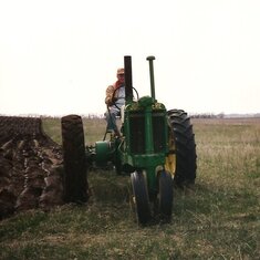 So proud of his John Deere tractors.