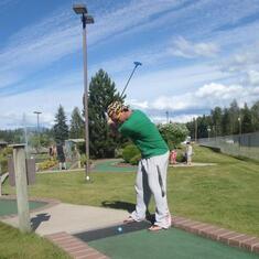 Dustin taking his golf swing at Mini Put!