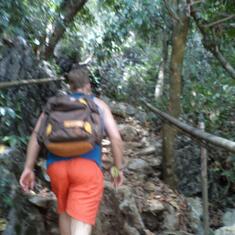 Dustin walking up the mountain side to get to the entrance of the cave.
