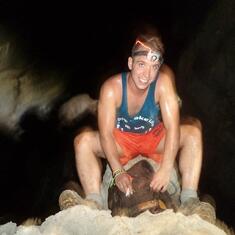 Dustin at the top of a big point in the cave. Smiling :)
