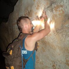 Dustin being a heart throb carving something in a cave in Vang Vieng, Loas.